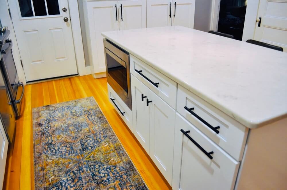 White cabinetry with quartz countertop and backsplash