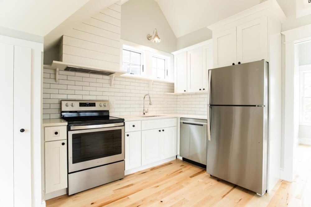 Homeowner measuring a kitchen in Palm Beach County before requesting the free e-book