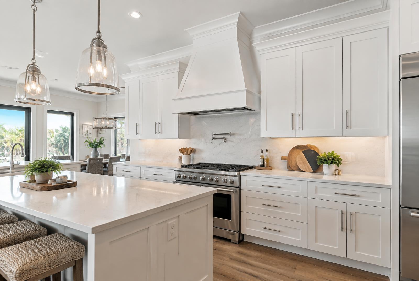 Custom wood range hood above a cooktop with matching floating shelves in a West Palm Beach kitchen